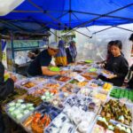 Diverse offerings at a vibrant street food market in Jawa Barat, Indonesia.